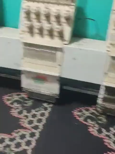 Multi-head embroidery machine stitching a neckline at AT80 Stitching Studio